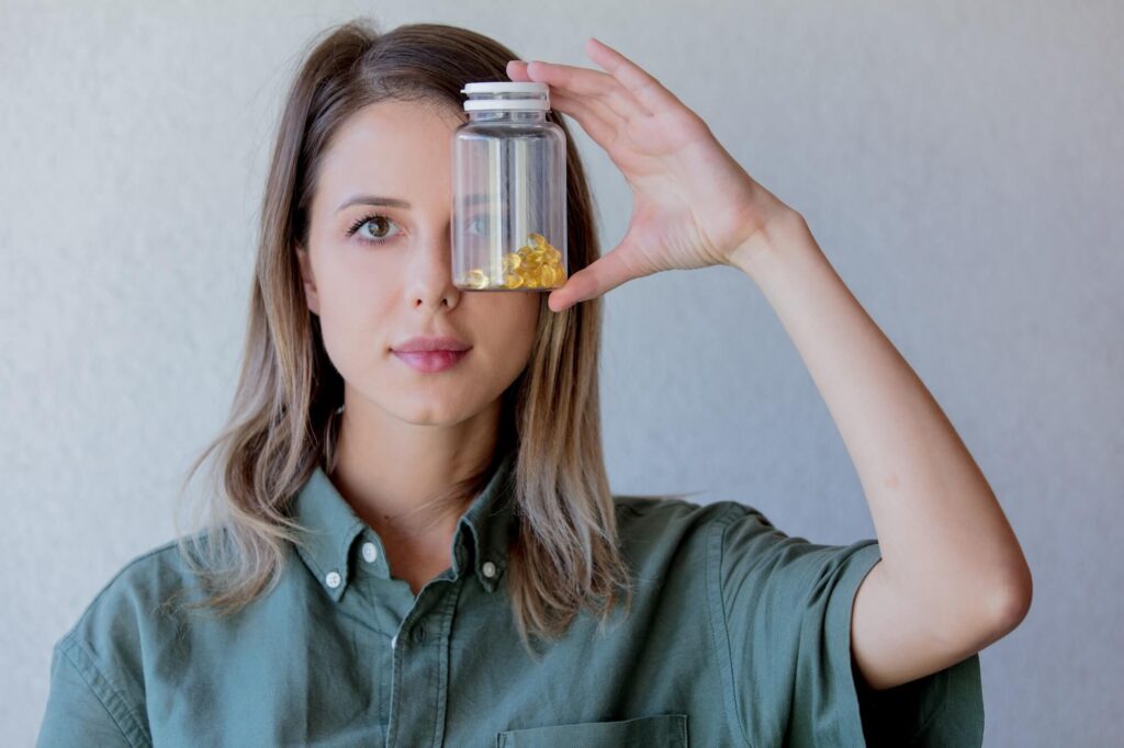 Woman holding a bottle of fertility supplements, highlighting the importance of preconception vitamins for optimizing fertility at Mythri Fertility Centre.